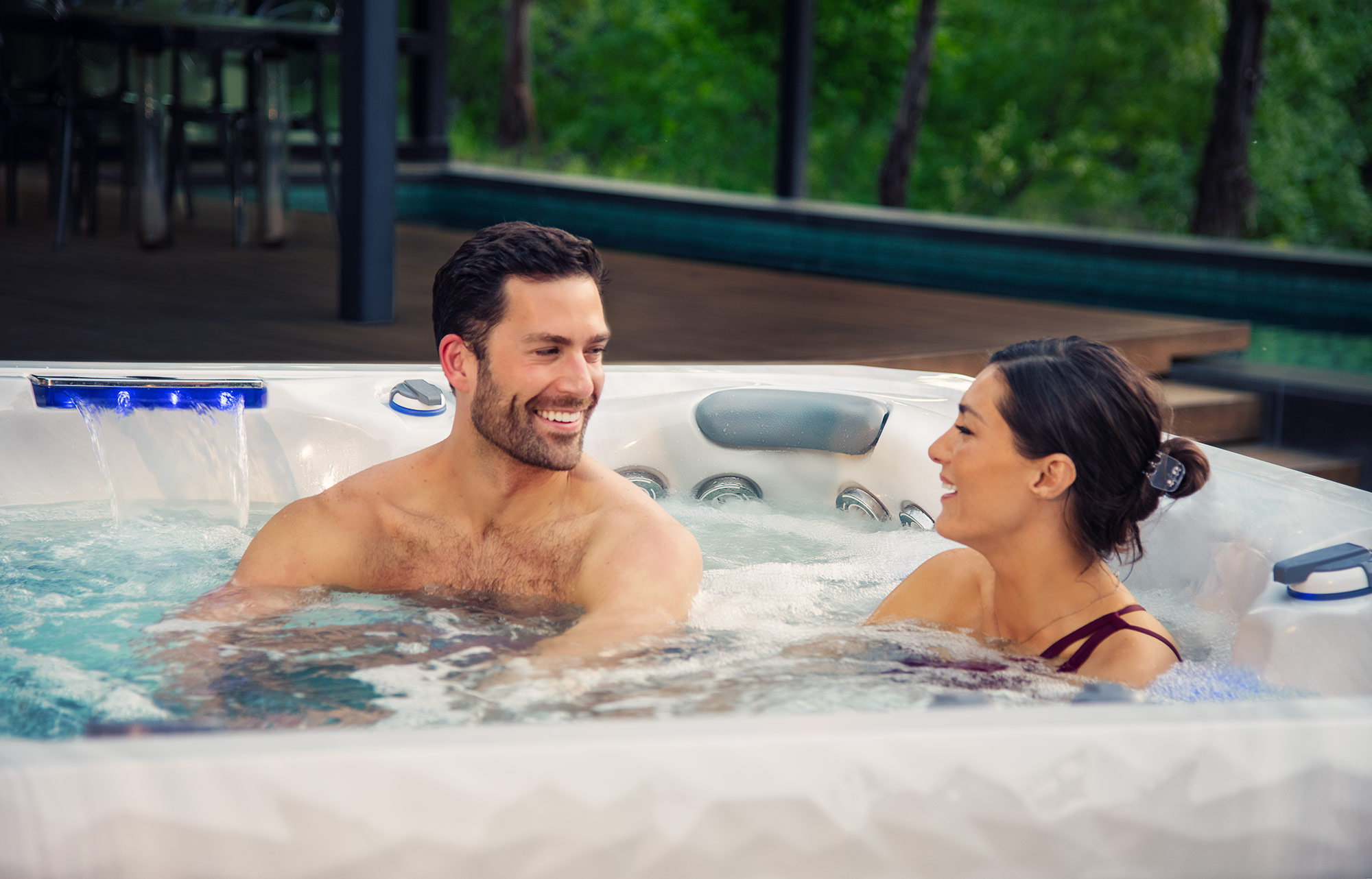 Couple in a backyard Master Spas hot tub
