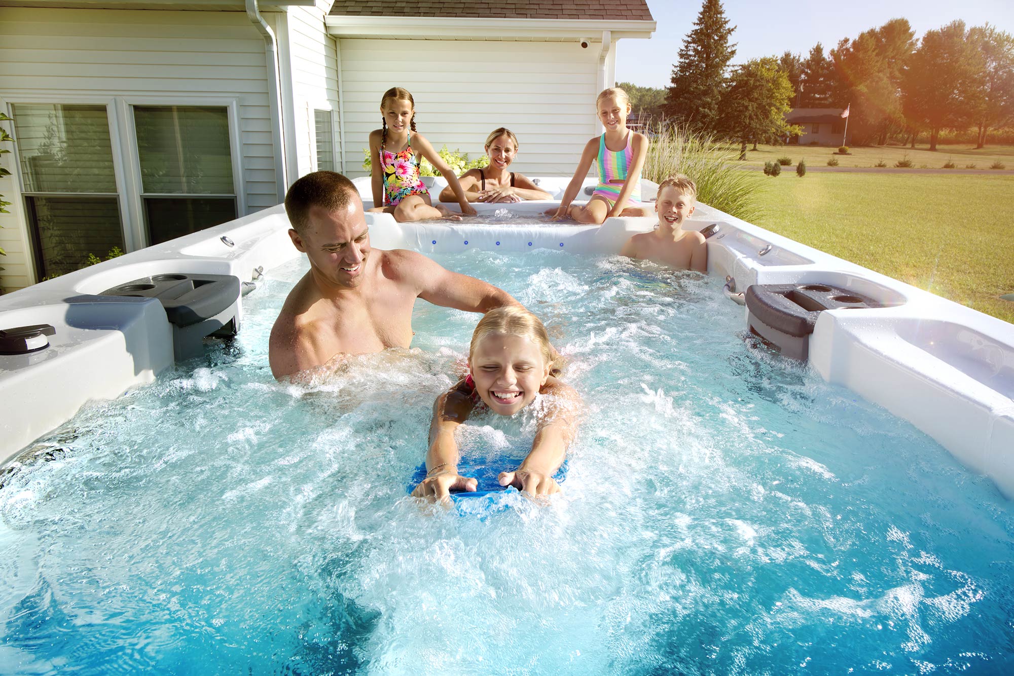 Family in a Master Spas swim spa